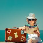 woman with vintage suitcase and city map on vacation