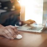 Close up of man working on laptop