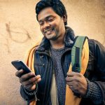 Young man holding mobile phone