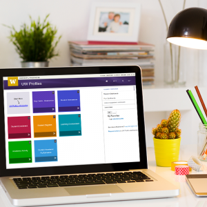 Laptop on a desk with UW Profiles dashboard on the screen