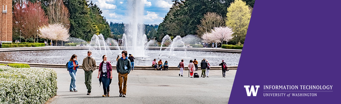 People walking in front of Drumheller foundtain with the UW Information Technology on the right side.