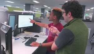 UW-IT student and supervisor reviewing content on a website.