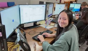 UW-IT student employee working at desk.