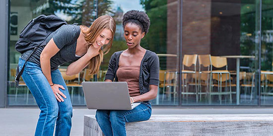 students working on a laptop