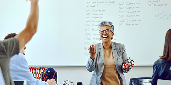 Classroom with teacher and students at a university setting.